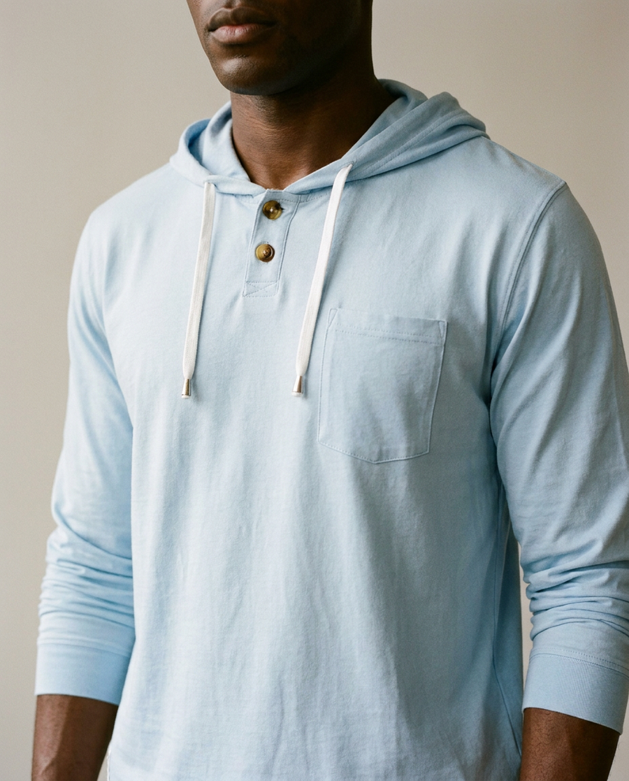 Close crop of the Deep Point Hoodie in Bell blue showing the button placket, drawcords and chest pocket