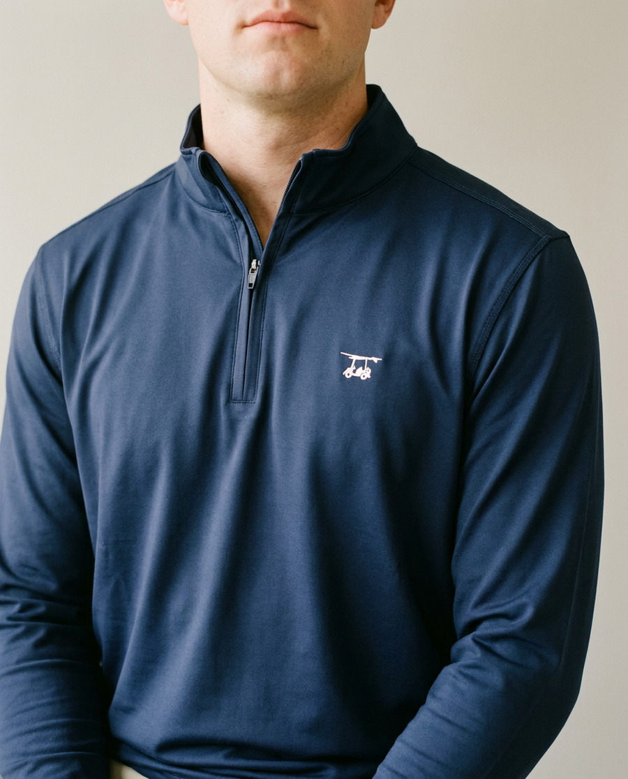Close crop of the navy Ocean View quarter zip showing the zip placket, stand collar and a small flat cart mark on the chest