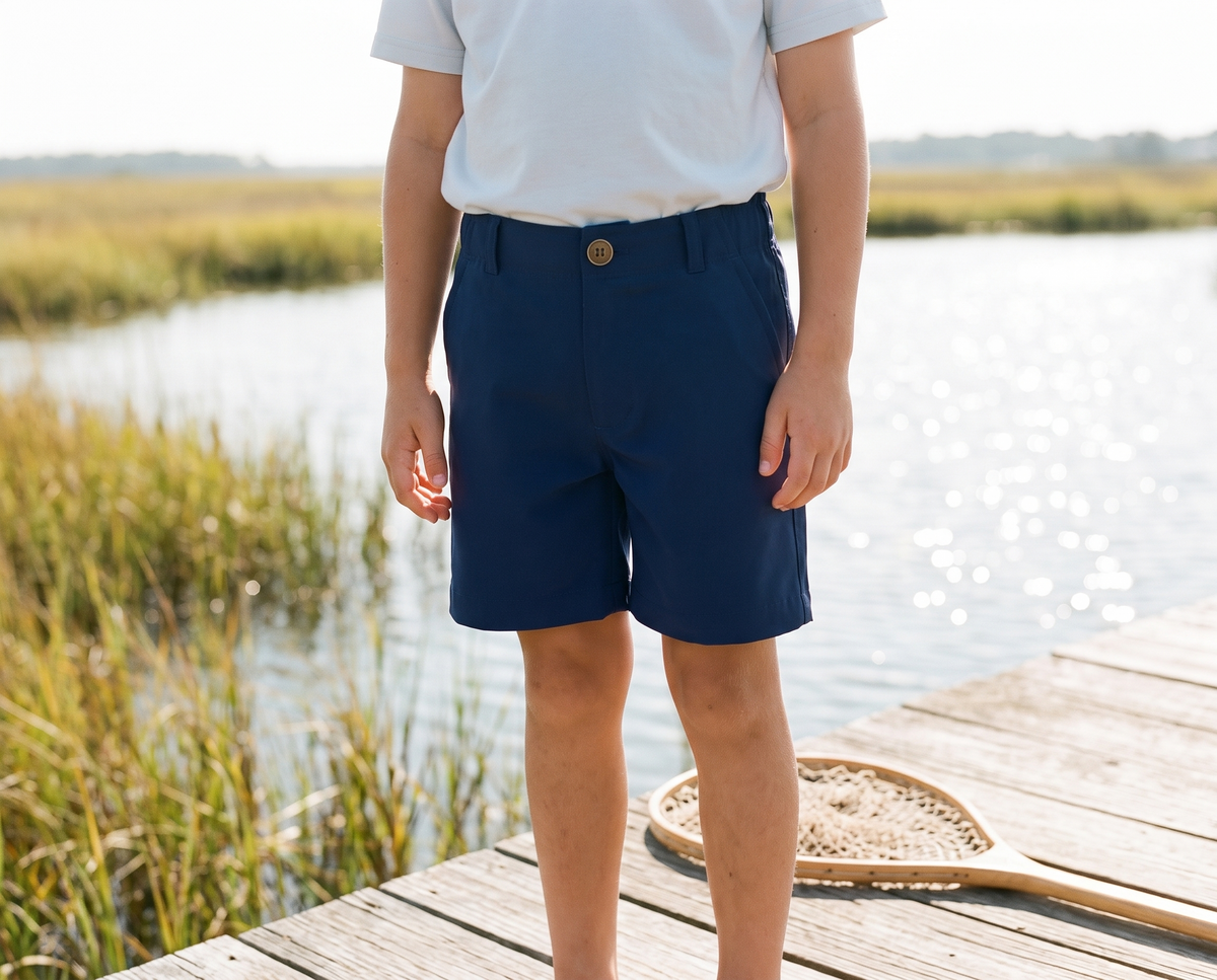 Boy on a marsh dock in Bald Head Blues Youth Performance Shorts in Medieval