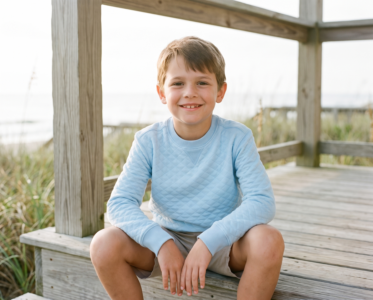 Boy on a porch step in the Bald Head Blues Youth Cape Crew Neck in Bell