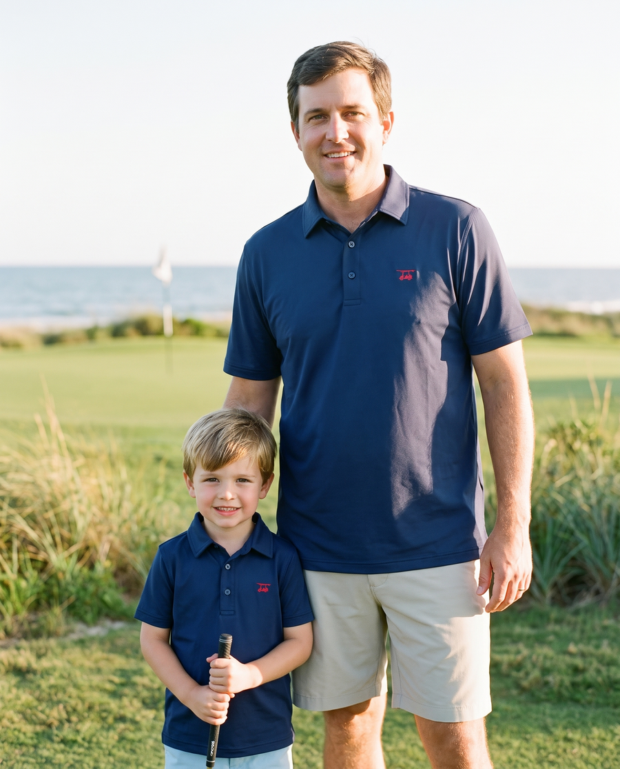 Father and son in matching Bald Head Blues Albatross polos in Medieval on a seaside golf course
